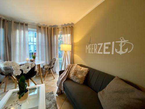 a living room with a couch and a table at Meerzeit in Zingst