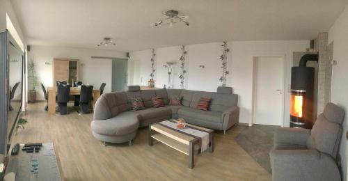 a living room with a couch and a table at Ferienwohnung "Haaler Au" in Haale