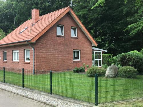 a red brick house with a red roof at Kleymann RE26 in Sögel
