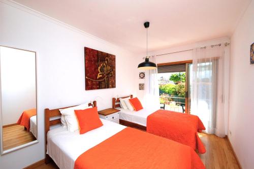 a bedroom with two beds and a window at Apartment Karin, Town Centre in Tavira