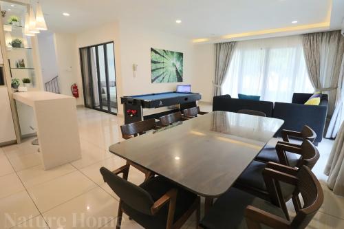 a dining room with a ping pong table and chairs at Nature Home 2 - Swiss Garden Resort Residences Beachfront Villa in Kuantan