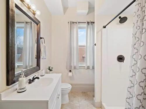 a bathroom with a sink and a toilet and a mirror at Victorian Estates - Cute Stuido - Steps To Clinic in Cleveland