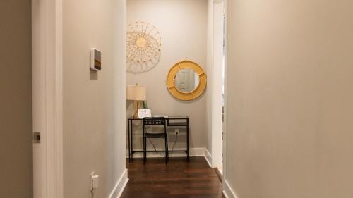 a hallway with a table and a mirror at Cozy Room Queen Bed Private Bathroom Fast Wifi in Lithonia