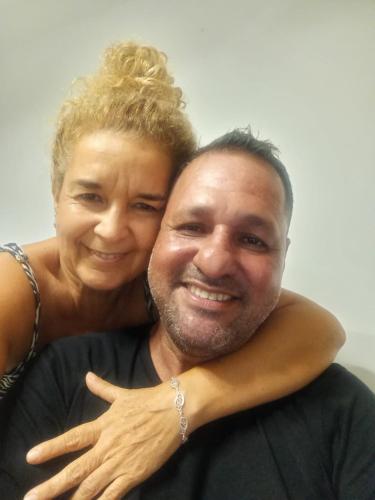 a man and a woman hugging each other at Backpack Cabin A 49149 in Oranjestad