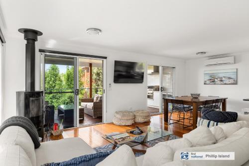 a living room with a couch and a fireplace at Seadale in Rhyll