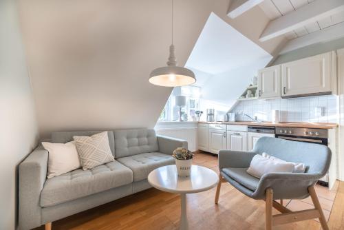 a living room with a couch and a table at Landhaus am Meer - Whg 8 Westerley in Utersum