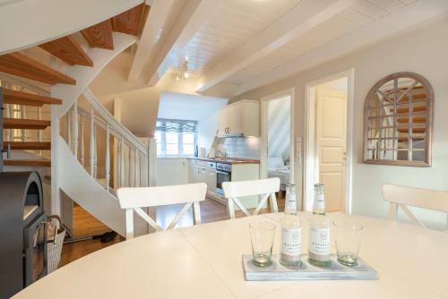 a kitchen with a table with wine glasses on it at Landhaus am Meer - Whg 7 Osterley in Utersum