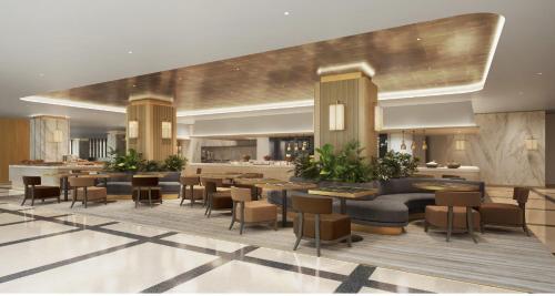 a lobby of a hotel with tables and chairs at RIHGA Royal Hotel Osaka, Vignette Collection by IHG in Osaka