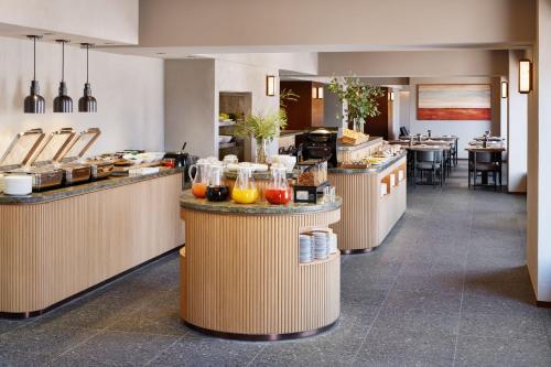a restaurant with a buffet line with food at RIHGA Royal Hotel Osaka, Vignette Collection by IHG in Osaka