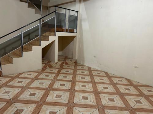a hallway with a staircase and a tiled floor at My home in Sucúa in Sucúa