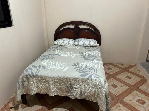 a bed in a corner of a room at My home in Sucúa in Sucúa