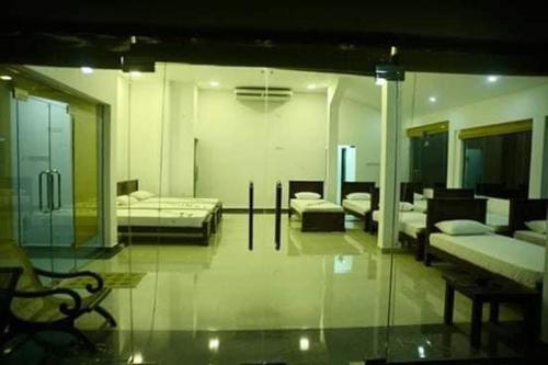 a room with two beds and a glass wall at Crocodile park Bungalow in Kataragama
