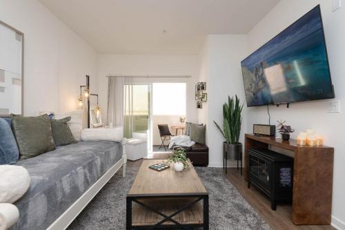 a living room with a couch and a fireplace at Hollywood Apartment Near Walk of Fame in Los Angeles