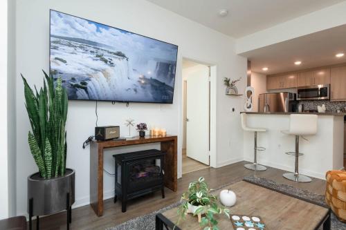a living room with a fireplace and a kitchen at Hollywood Apartment Near Walk of Fame in Los Angeles