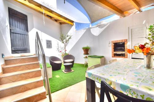 a room with a table and chairs and a staircase at BeGuest Alcantarilha Family Home in Alcantarilha