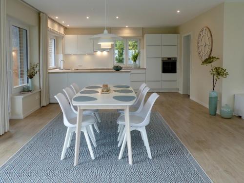 a kitchen and dining room with a table and chairs at Hof Wittensee, Seeperle in Klein Wittensee