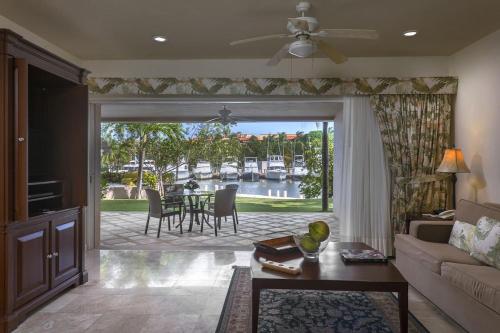 a living room with a couch and a table with chairs at Portobello Gran Marina in Puerto Aventuras