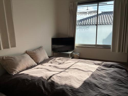 Una cama o camas en una habitación de モリステイ