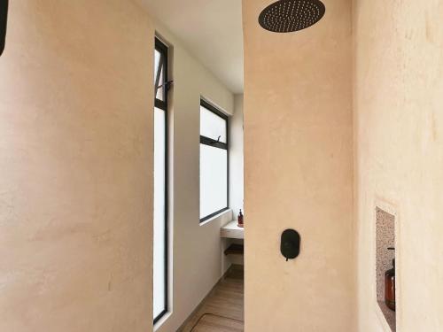 a hallway of a house with a window and a sink at Aymara Punta Zicatela in Brisas de Zicatela