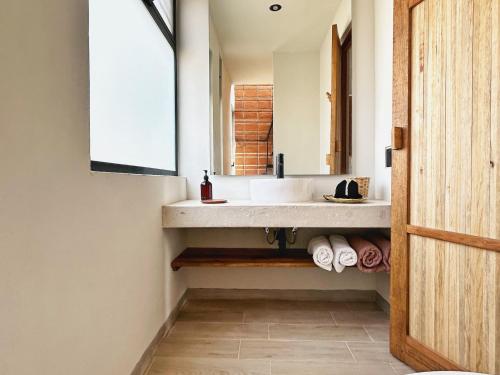 a bathroom with a sink and a mirror at Aymara Punta Zicatela in Brisas de Zicatela