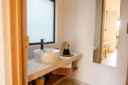 a bathroom with a sink and a mirror at Aymara Punta Zicatela in Brisas de Zicatela