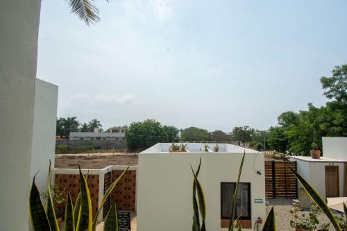 a white building with plants in front of it at Aymara Punta Zicatela in Brisas de Zicatela