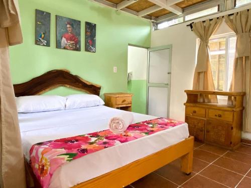 a bedroom with a bed and a dresser in it at Frida Paradise Beach Hotel - Punta Zicatela in Brisas de Zicatela