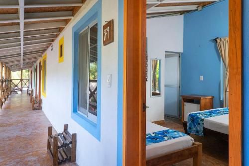 a room with two beds and a window at Frida Paradise Beach Hotel - Punta Zicatela in Brisas de Zicatela