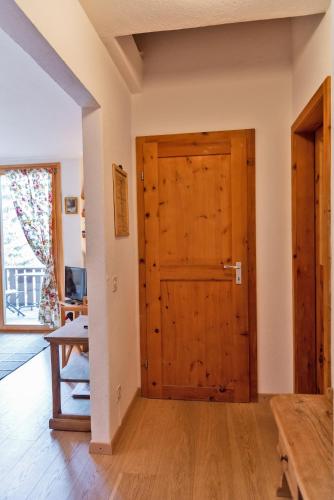 a room with a wooden door and a table at Chesa Alvra - Celerina in Celerina