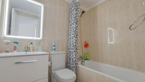 a bathroom with a toilet and a sink and a shower at La Siesta Perfecta in Villacosta