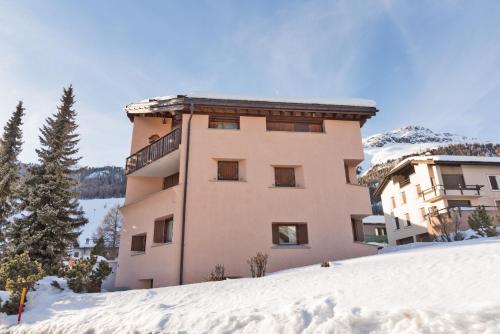 a building on top of a snow covered slope at Chesa Alvra - Celerina in Celerina