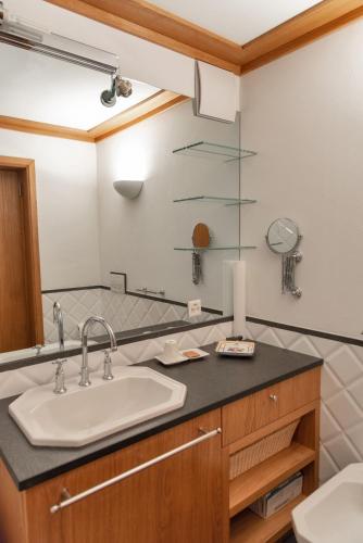 a bathroom with a sink and a mirror at Chesa Viroula - Zuoz in Zuoz
