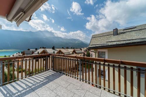 a balcony with a view of the mountains at Chesa La Buot - Silvaplana in Silvaplana