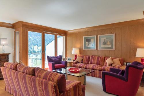 a living room with a couch and chairs and a table at Chesa Viroula - Zuoz in Zuoz