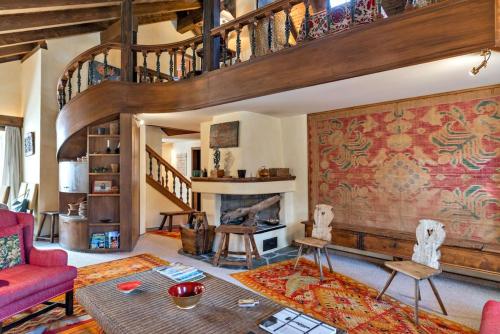 a living room with a red couch and a fireplace at Chesa Cromer - Celerina in Celerina