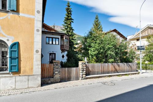 a house on the side of a street with a fence at Chesa Cromer - Celerina in Celerina