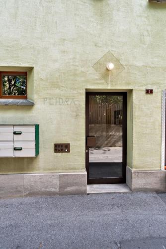 a door to a building with a window and a building at Chesa Pedra - Celerina in Celerina