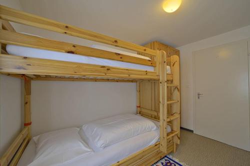 a bedroom with two bunk beds in a room at Chesa Giandains - Pontresina in Pontresina