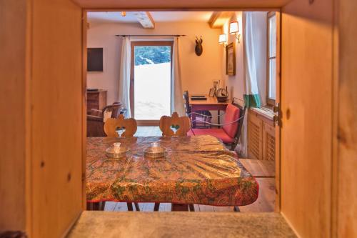 a dining room with a table and chairs in a room at Chalet Gulas - La Punt-Chamues-ch in La Punt-Chamues-ch