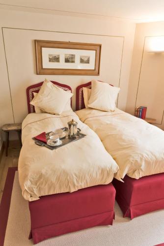 a bedroom with two beds with a tray on top at Chesa Platz - Bever in Bever