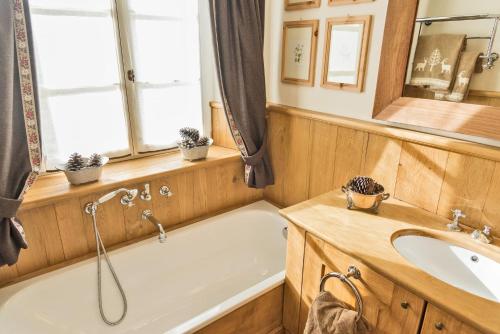 a bathroom with a tub and a sink at Chesa Platz - Bever in Bever