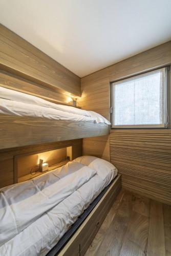 a bedroom with two bunk beds and a window at Chesa Allegra - Celerina in Celerina
