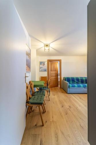 a room with two chairs and a bed at Chesa Al Munt - Celerina in Celerina