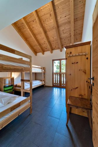 a room with two bunk beds and a window at Engadina Chesa Gluna - Madulain in Madulain
