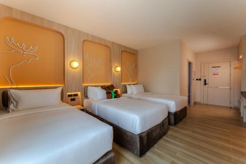 Un ou plusieurs lits dans un hébergement de l'établissement Moose EASY Hotel