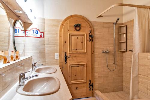 a bathroom with two sinks and a shower at Chesa Romana - Silvaplana in Silvaplana