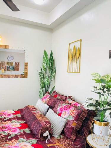 a living room with a couch with pillows on it at EM Suite Homestay in Kota Bharu