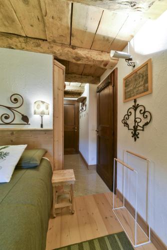 a bedroom with a bed and a wooden ceiling at Chesa Crasta - Celerina in Celerina