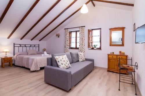 a living room with a couch and a bed at Apartamentos & Bungalows Ubiarco El Acebo by Urbanhosting in Ubiarco