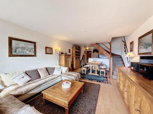 a living room with a couch and a table at Astoria 127 in Verbier